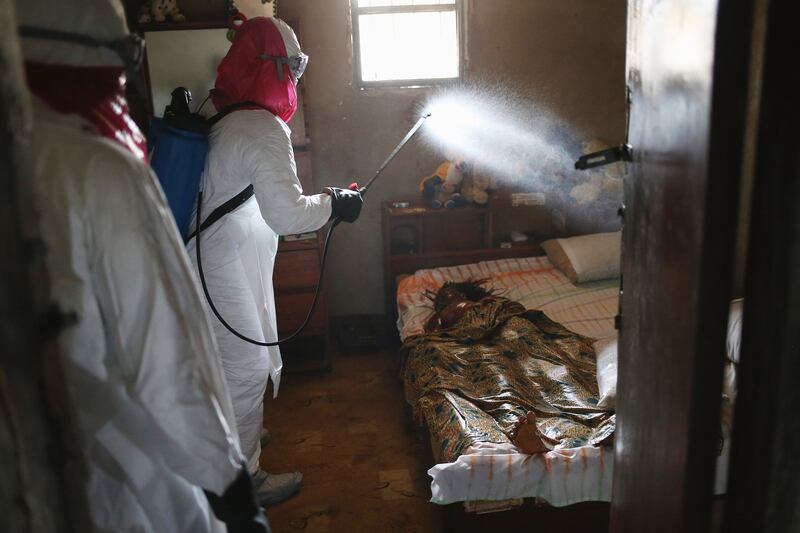 galleries/2014/10/23/portrait-of-an-epidemic-the-front-lines-of-ebola/141022-john-moore-ebola-12_kvq5sr
