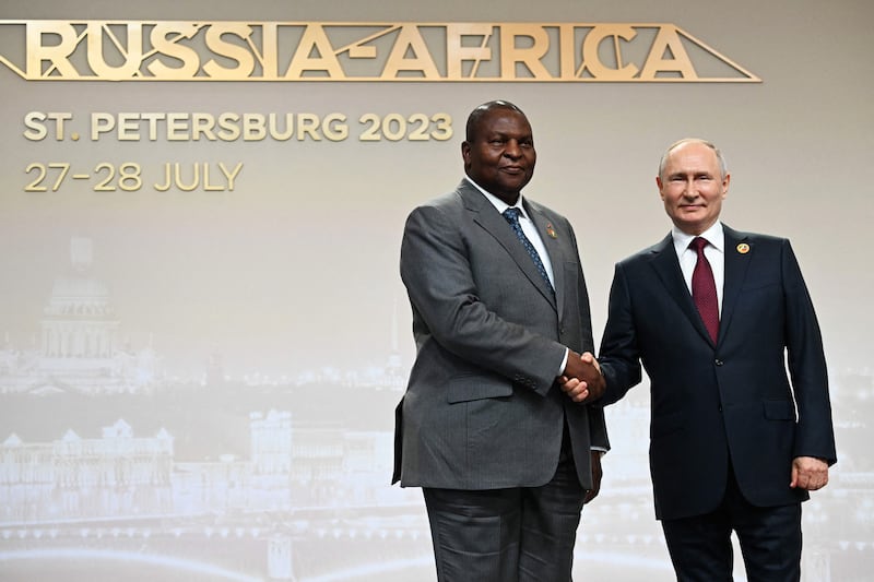 A photograph of Russian President Vladimir Putin greeting Central African Republic President Faustin-Archange Touadera during a welcoming ceremony at the second Russia-Africa summit in Saint Petersburg on July 27, 2023.
