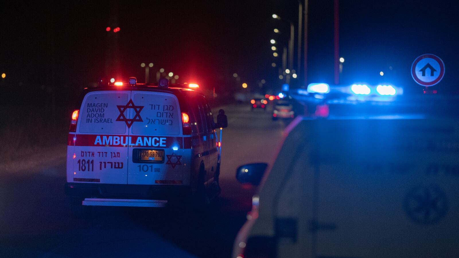 Emergency services and police block the road to the scene of a drone strike by Hezbollah