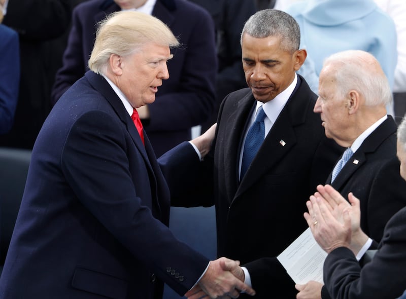 U.S. President Donald Trump (L) greets former Vice President Joe Biden and former President Barack Obama after being sworn in as the 45th president of the United States on the West front of the U.S. Capitol in Washington, U.S., January 20, 2017.   REUTERS/Lucy Nicholson