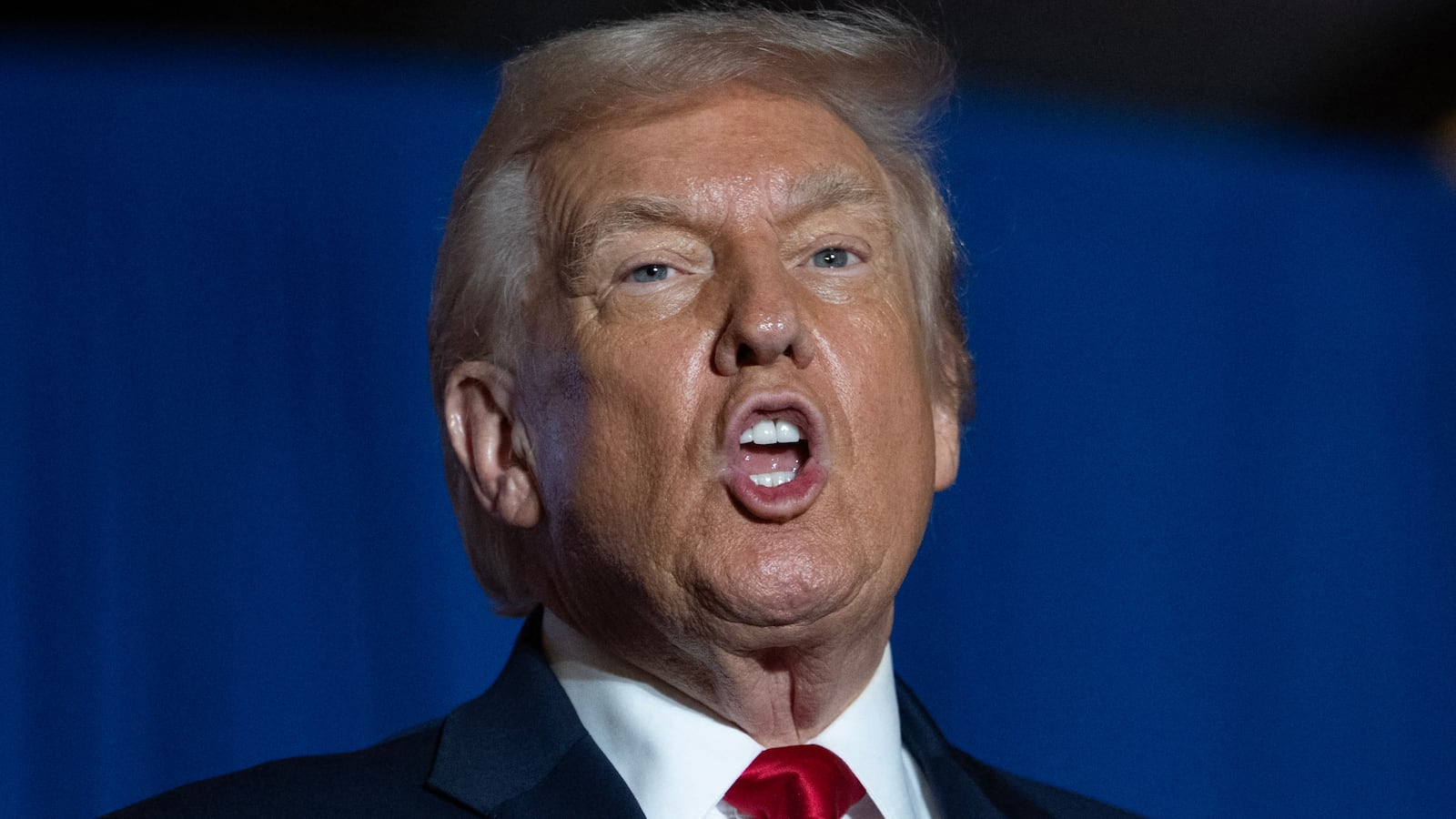 US President Donald Trump sings upon his arrival to deliver remarks on the economy at Mount Airy Casino Resort in Mount Pocono, Pennsylvania, on December 9, 2025. (Photo by ANDREW CABALLERO-REYNOLDS / AFP via Getty Images)
