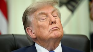 President Donald Trump closes his eyes before signing an executive order calling for more research and flexibility on vaccines, in the Oval Office of the White House in Washington, DC, on August 10, 2026.