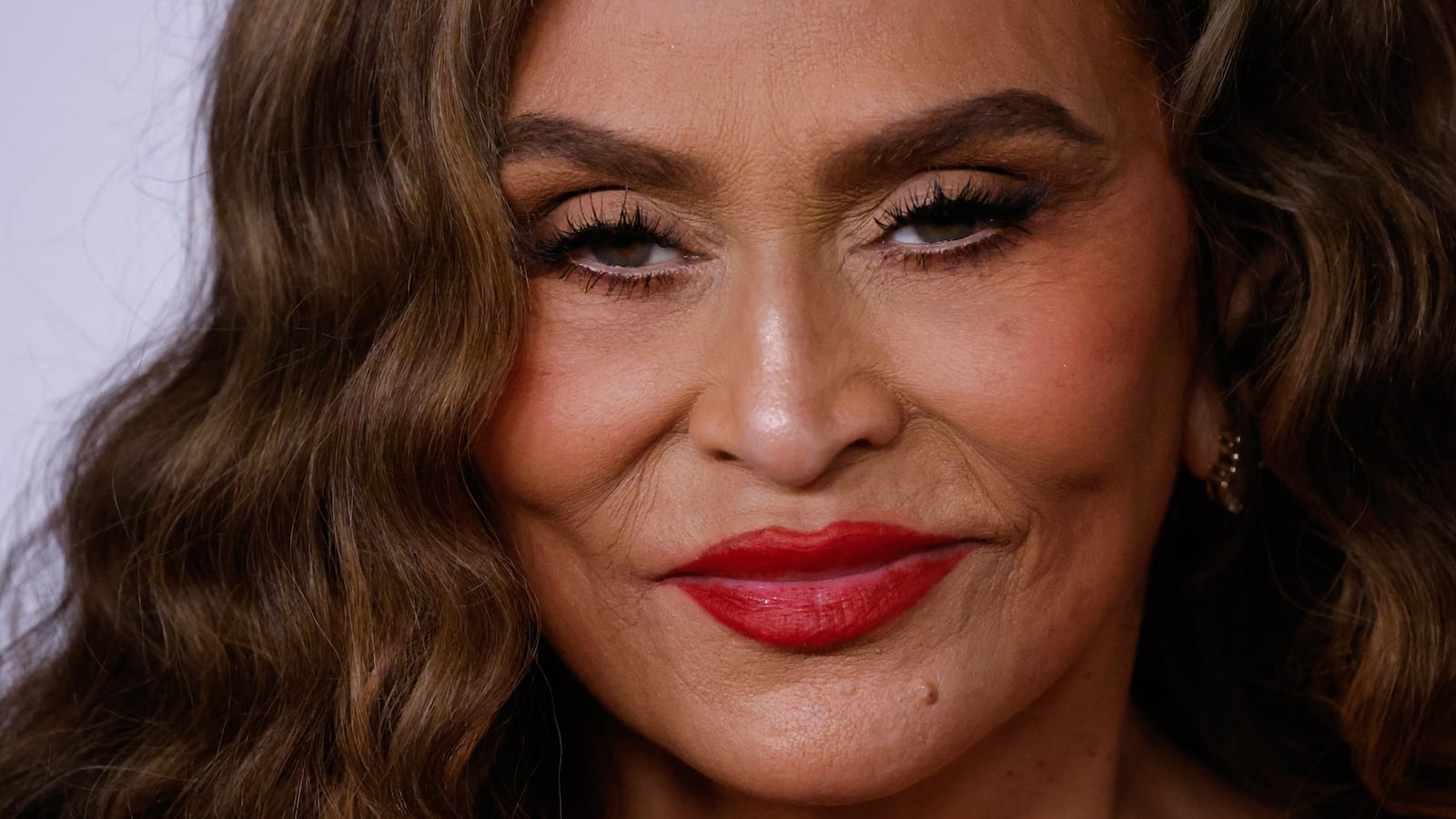 Tina Knowles smirks.
