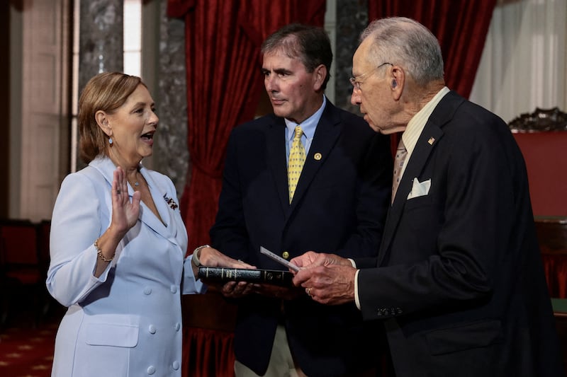 Senator for South Carolina Darline Graham Nordone, sister of late Senator Lindsey Graham, is ceremonially sworn-in by U.S. Senate President pro tempore Chuck Grassley next to her husband Larry Nordone during an event on Capitol Hill in Washington, D.C. on July 14, 2026.