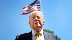 President Donald Trump speaks in front of the American flag to the press as he departs the White House on May 12, 2026 in Washington, DC.