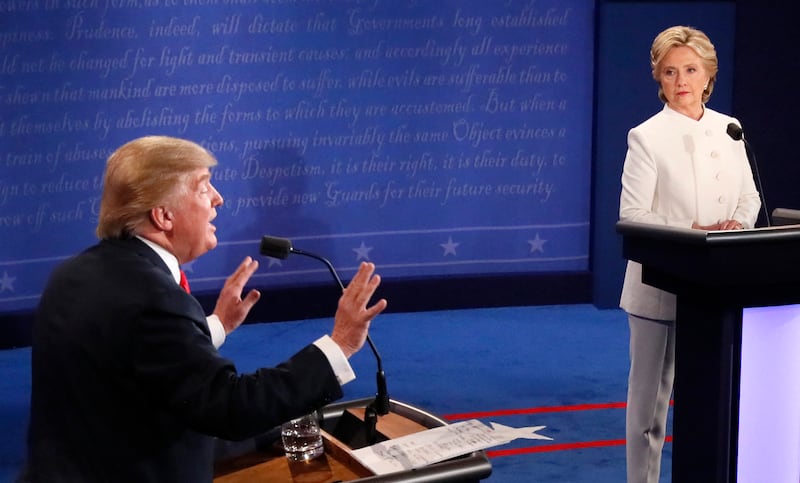 Republican nominee Donald Trump speaks as Democratic nominee Hillary Clinton looks on during the final presidential debate at the University of Las Vegas in Las Vegas, Nevada on October 19, 2016.