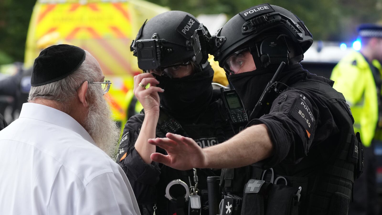 MANCHESTER, ENGLAND - OCTOBER 2: Members of the public and congregants seen as Police and other emergency responders attend the Heaton Park Hebrew Congregation Synagogue, where multiple were injured after stabbing and car attack on Yom Kippur, on October 2, 2025 in the Crumpsall suburb of Manchester, England. Greater Manchester Police said they were called to the scene shortly after 9:30 AM, when a witness said the assailant drove a car at people and then stabbed someone. Police then shot the suspected attacker. (Photo by Christopher Furlong/Getty Images)