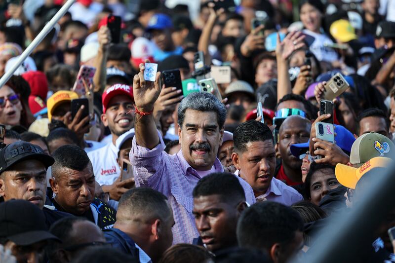 dpatop - 13 November 2025, Venezuela, Caracas: Venezuelan President Nicolas Maduro shows a picture of Saint Jose Gregorio Hernandez during a pro-government youth rally. Photo: Jesus Vargas/dpa (Photo by Jesus Vargas/picture alliance via Getty Images)