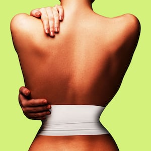 Woman from the back with a very small waist and a bandage around it