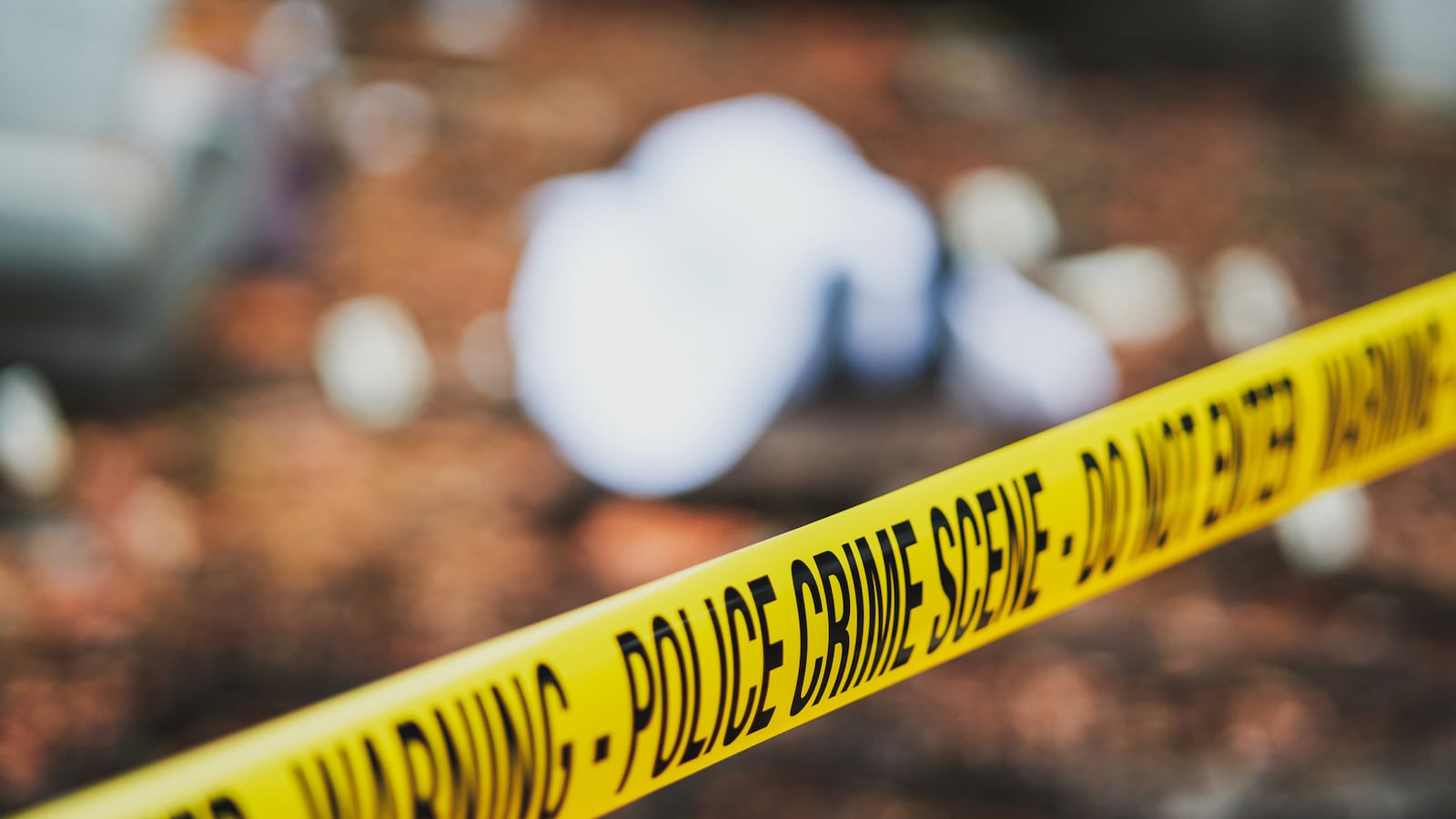 Caution tape seen at a crime scene.