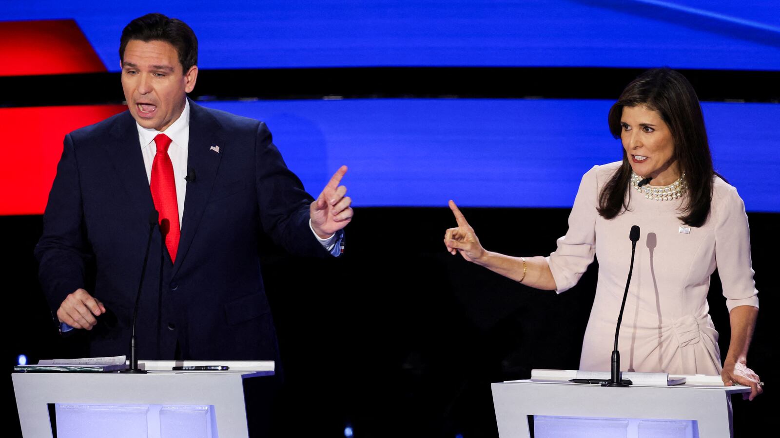 Ron DeSantis and Nikki Haley debate on stage.