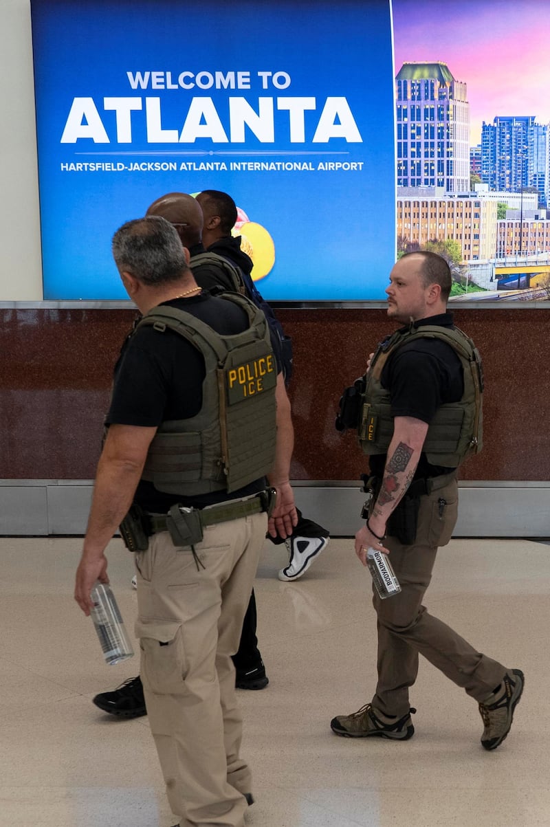 Immigration and Customs Enforcement (ICE) agents walk through Hartsfield-Jackson Atlanta International Airport after hundreds of Immigration and Customs Enforcement agents were ordered to deploy to airports to help fill TSA staffing gaps, at Hartsfield-Jackson Atlanta International Airport in Atlanta, Georgia, U.S., March 24, 2026. REUTERS/Alyssa Pointer