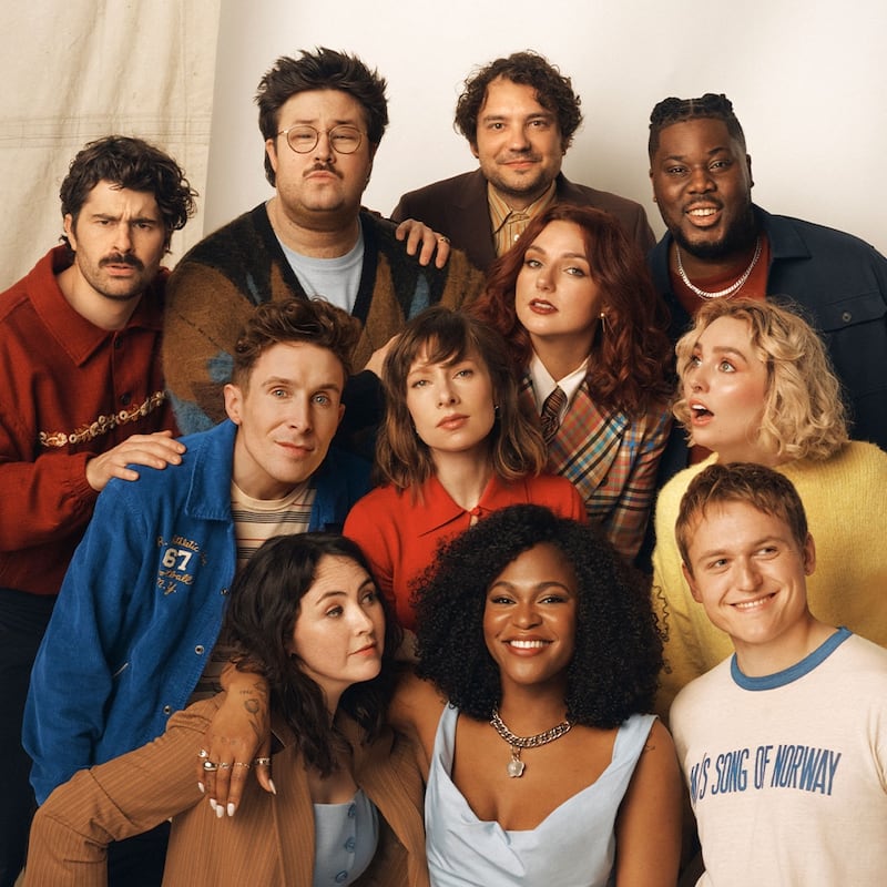 SNL cast standing together.