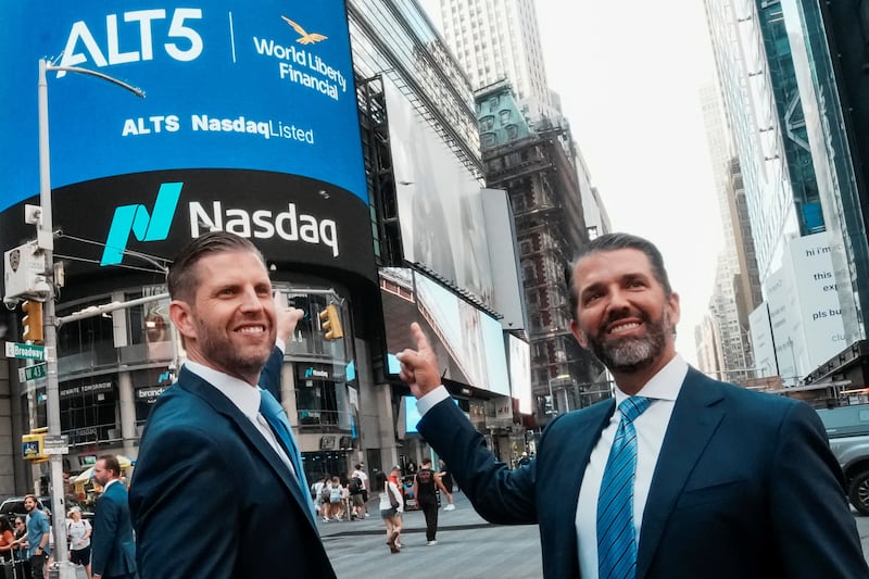 Donald Trump Jr. and Eric Trump pose for pictures outside the Nasdaq building after ringing the opening bell to celebrate the closing of ALT5’s $1.5 billion offering and adoption of its $WLFI Treasury Strategy at the Nasdaq Market, in New York City, U.S., August 13, 2025.  REUTERS/Eduardo Munoz