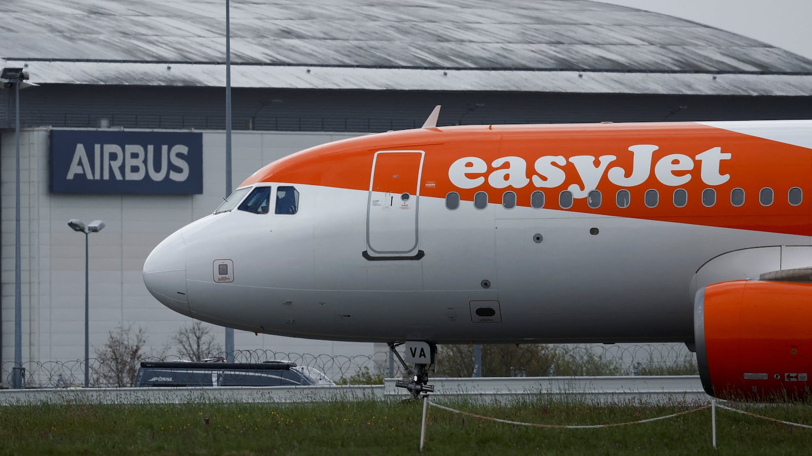 An easyJet Airbus A320-214 Aircraft prepares to take off from the Nantes Atlantique Airport in front of an Airbus facility, in Bouguenais near Nantes, France,