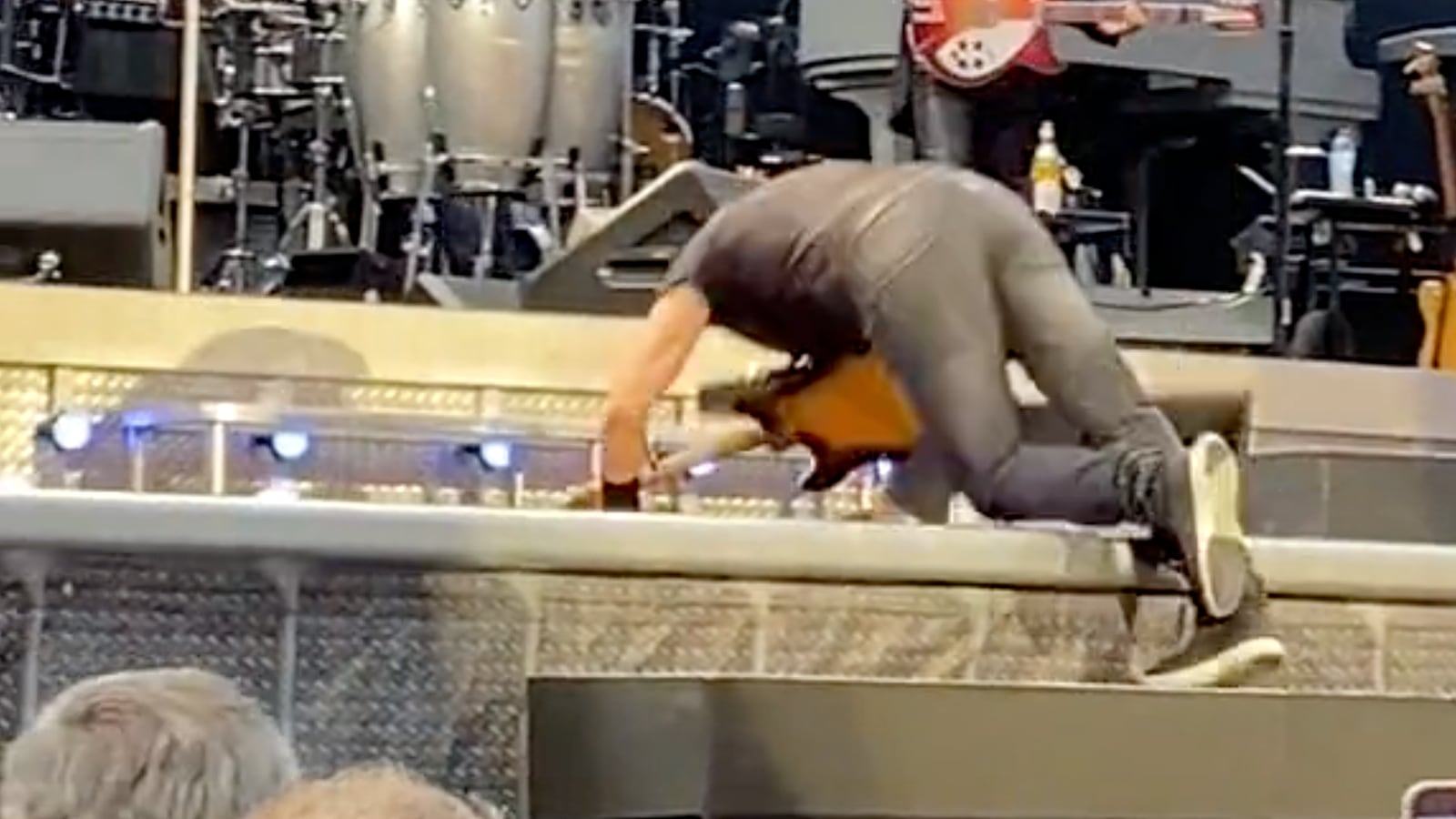 Bruce Springsteen falls on stage.