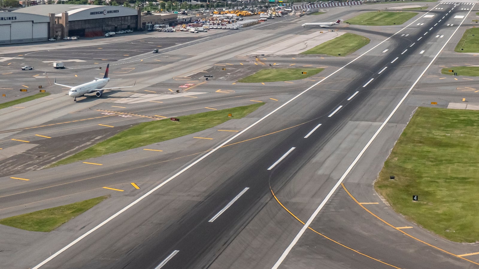 Aerial view of the runway, taxiway, hangar and aircraft of LaGuardia Airport. General view of the LaGuardia Airport LGA with the terminal, apron, taxiway, runway and passenger aircraft. LaGuardia is a civil airport in East Elmhurst, Queens, New York City, USA operating domestic and international flights. The owner is Port Authority of New York and New Jersey. Air Canada, American Airlines, American Eagle, Delta Air Lines, Delta Connection, Frontier Airlines, JetBlue, Southwest Airlines, Spirit Airlines, United Airlines and United Express operate from the airport. LaGuardia has three active terminals A, B, C with 72 gates. LaGuardia is undergoing a multi-billion dollar redesign that resulted in a new Terminal B and a new Terminal C. LaGuardia Airport, NYC, United States of America on May 11, 2023 (Photo by Nicolas Economou/NurPhoto via Getty Images)