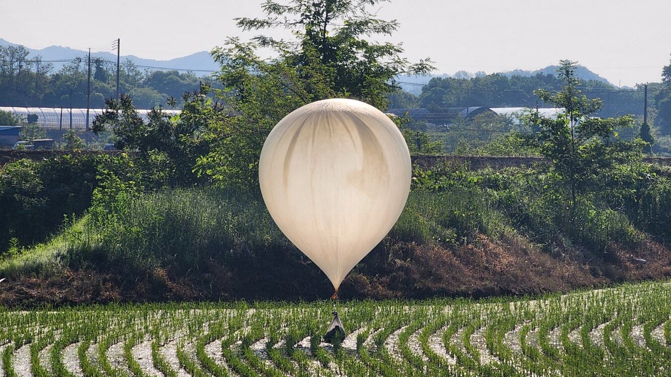A balloon believed to have been sent by North Korea, carrying various objects including what appeared to be trash and excrement, is seen over a rice field at Cheorwon, South Korea, May 29, 2024.