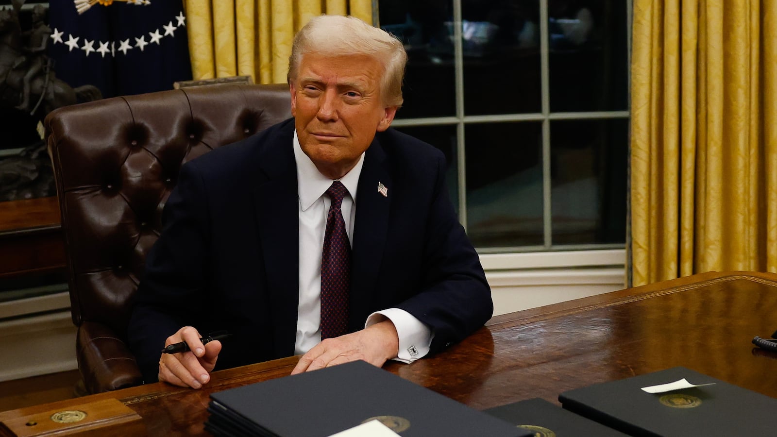 President Donald Trump signs executive orders in the Oval Office on January 20, 2025 in Washington, DC.