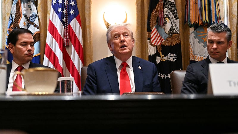 President Donald Trump (C) speaks, alongside Secretary of State Marco Rubio (L) and Secretary of Defense Pete Hegseth (R), during a cabinet meeting in the Cabinet Room of the White House in Washington, DC, on Oct. 9, 2025. Trump said Thursday he would try to go to Egypt for the signing of a Gaza ceasefire and hostage release deal between Israel and Hamas.
