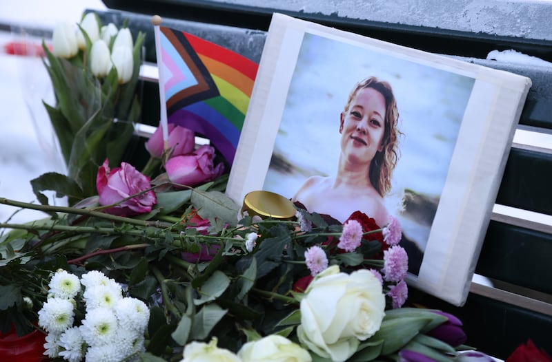 Flowers and candles are seen at a vigil for Renee Nicole Good in front of the United States embassy in Berlin, Germany.