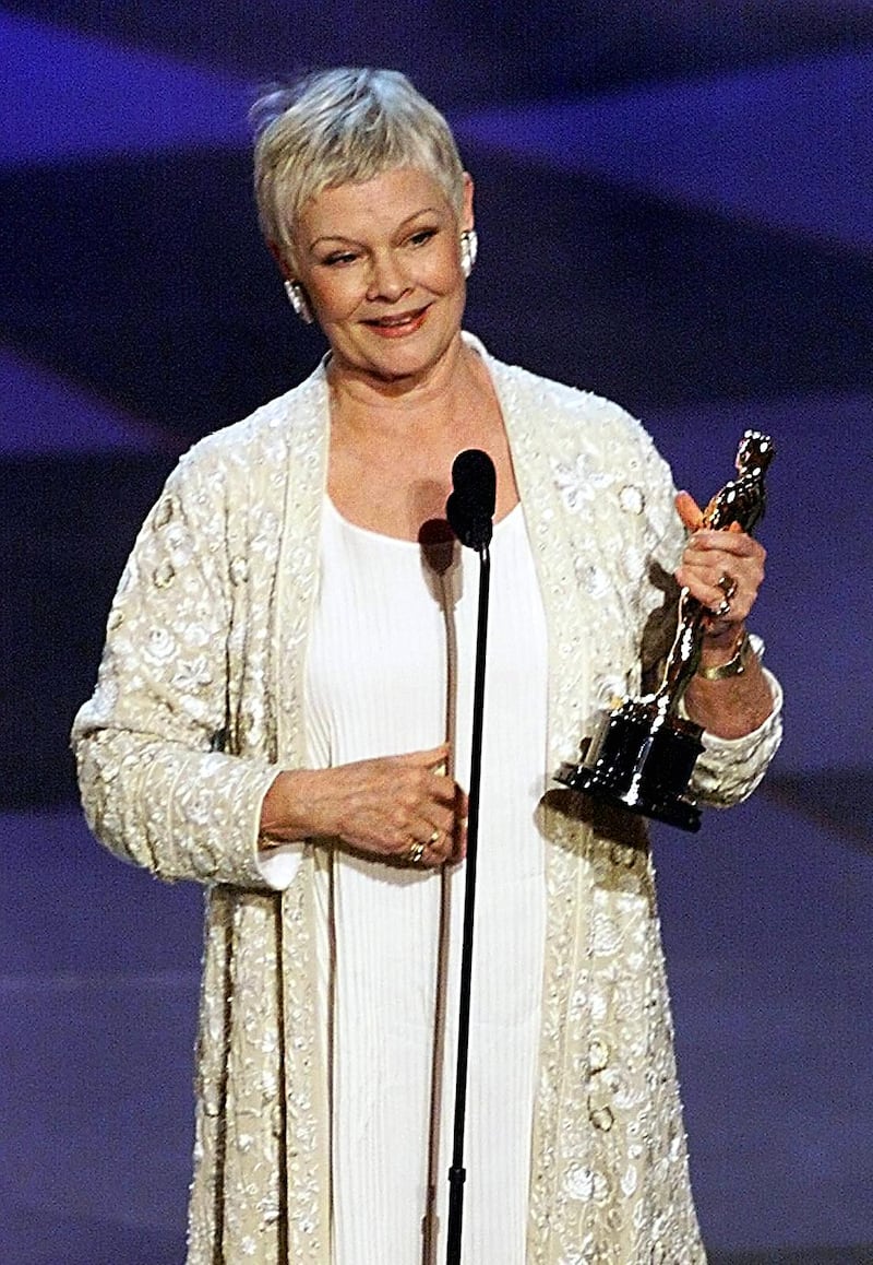 LOS ANGELES, UNITED STATES:  Actress Judi Dench holds her Oscar after winning for Best Performance by an Actress in a Leading Role for her part in the movie "Shakespeare in Love" during the 71st Academy Awards 21 March 1999 at the Dorothy Chandler Pavilion in Los Angeles,