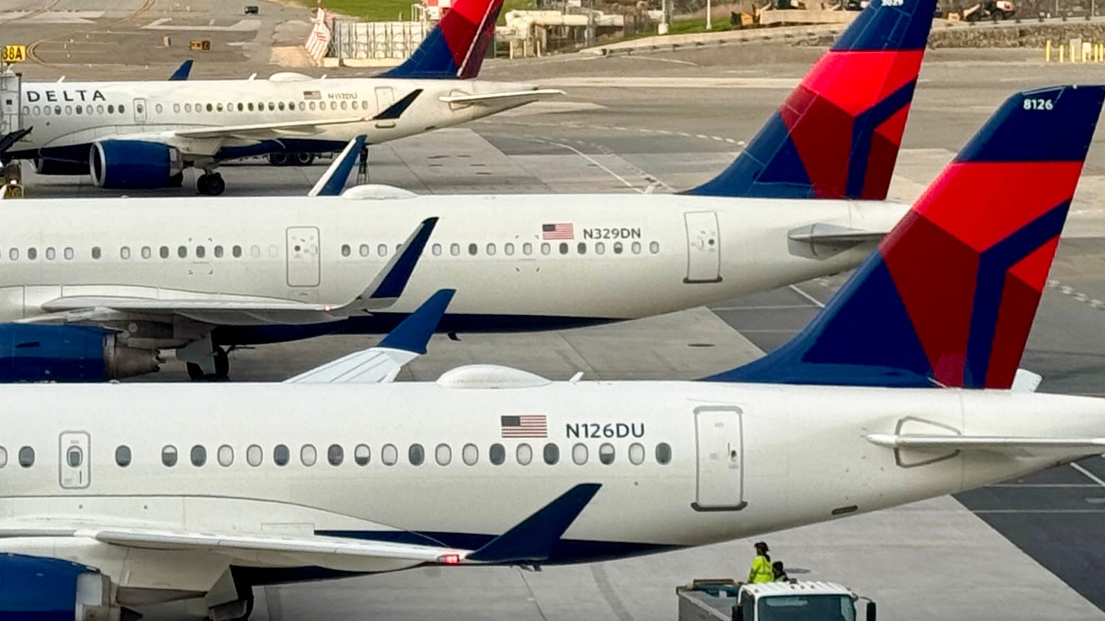 Delta airlines passengers planes, Airbus A220-100 (front) and Airbus A321-211 (second) sit at LaGuardia airport, in New York City, on April 18, 2025. (Photo by Daniel SLIM / AFP) (Photo by DANIEL SLIM/AFP via Getty Images)