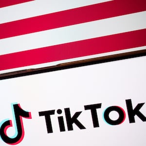 The TikTok logo appears on a smartphone screen, and the flag of the United States is on a computer screen as the background in this photo illustration on January 15, 2025.