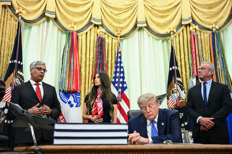 President Donald Trump slighly slumped with his eyes closed as the director of the National Institutes of Health (NIH) Jay Bhattacharya speaks before Trump signed an executive order calling for more research and flexibility on vaccines, in the Oval Office of the White House on August 10, 2026.