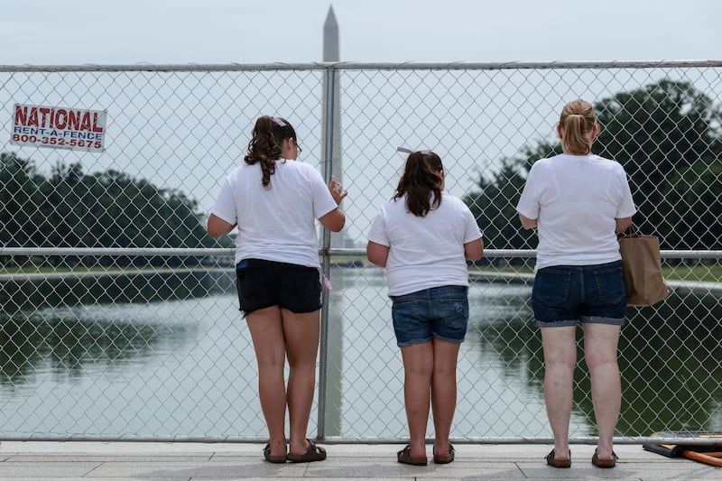 Visitors look through a fence encircling the Reflecting Pool in Washington, D.C., U.S., July 10, 2026.  REUTERS/Evelyn Hockstein
