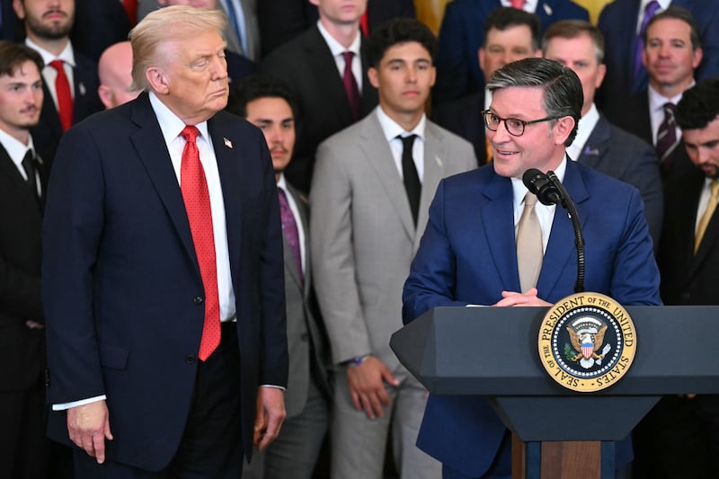 Donald Trump listens to Mike Johnson at the White House in Washington, DC, on October 20, 2025.