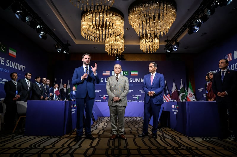 U.S. Vice President JD Vance speaks as Pakistan's Prime Minister Shehbaz Sharif and Qatar's Prime Minister and Minister for Foreign Affairs Sheikh Mohammed bin Abdulrahman bin Jassim Al-Thani greet each other before the start of a quadrilateral meeting between the U.S., Iran, Pakistan, and Qatar at the Lake Lucerne Summit, aimed at advancing a deal to end the Middle East conflict, at Buergenstock Resort Lake Lucerne, near Stansstad, Switzerland, June 21, 2026. REUTERS/Nathan Howard/Pool