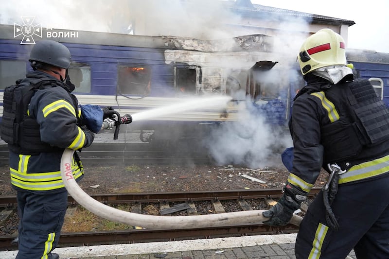 Firefighters extinguish a car of a passenger train hit by a Russian drone strike at a railway station, amid Russia's attack on Ukraine, in Lutsk, Ukraine September 12, 2026.