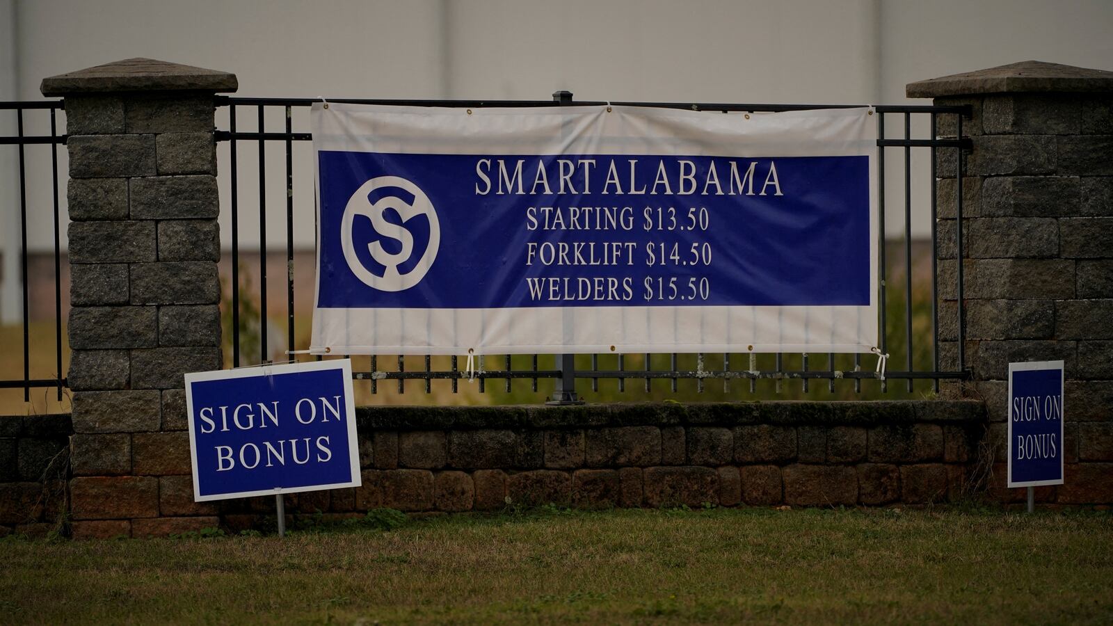 Signs advertise wages and bonuses in front of the SMART Alabama manufacturing facility in Luverne, Alabama, U.S., December 4, 2022.