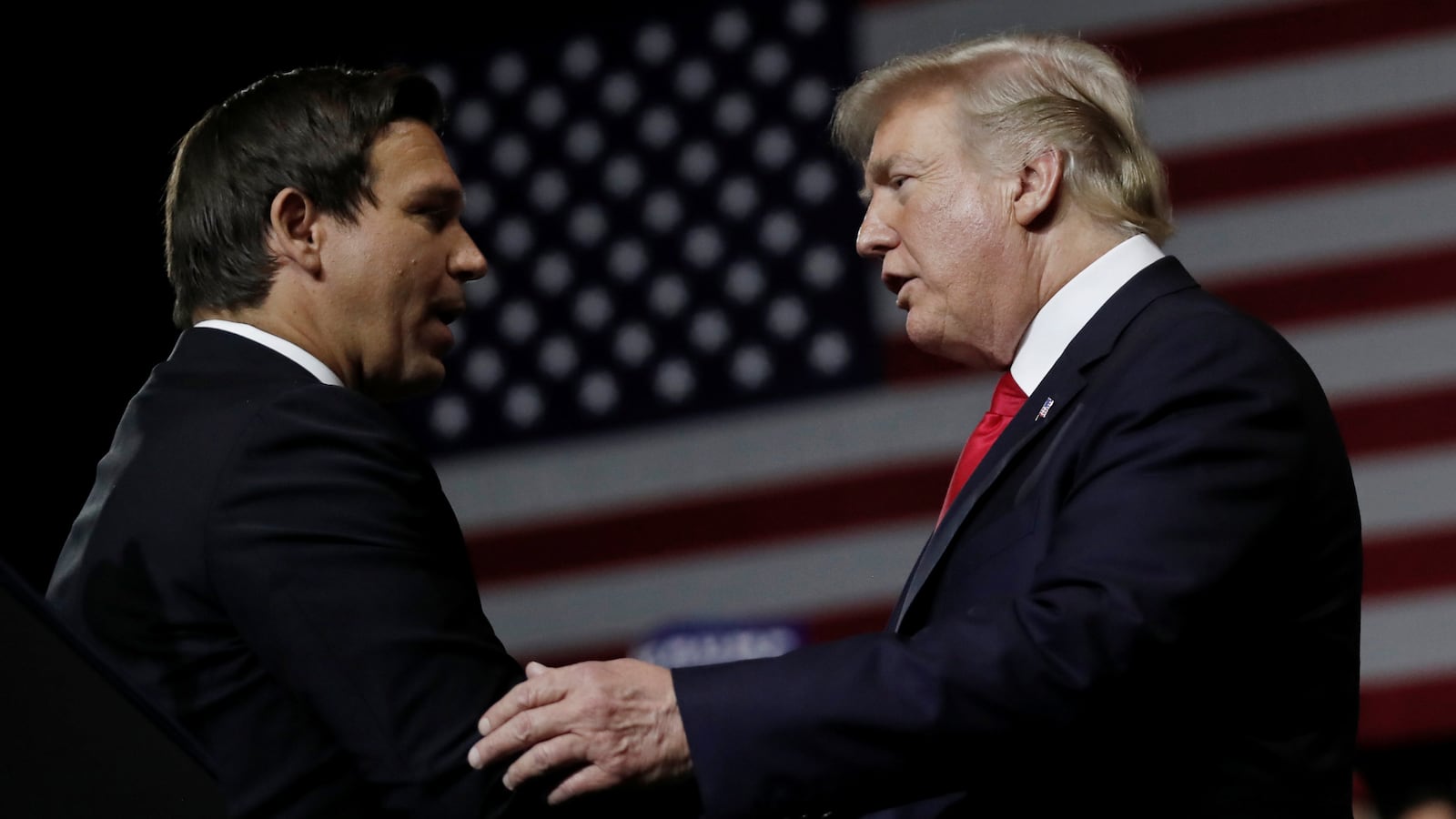 U.S. President Donald Trump talks with Republican Florida governor candidate Ron DeSantis during a Make America Great Again Rally at the Florida State Fairgrounds in Tampa, Florida, U.S., July 31, 2018.