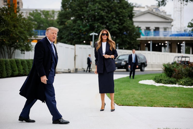 President Donald Trump, with first lady Melania Trump, walks to board Marine One to travel to Joint Base Andrews to greet Chinese President Xi Jinping, on the South Lawn of the White House in Washington, DC, September 23, 2026.