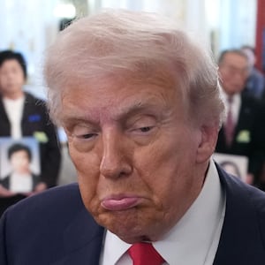TOKYO, JAPAN - OCTOBER 28: U.S. President Donald Trump (L) reacts to a reporter's question after taking a picture with Japanese Prime Minister Sanae Takaichi and family members of Japanese citizens who North Korea has abducted during a meeting at Akasaka Palace on October 28, 2025 in Tokyo, Japan. Trump is on a visit to Asia that takes in the ASEAN summit in Malaysia, followed by a trip to Japan and South Korea ahead of the APEC meetings. (Photo by Andrew Harnik/Getty Images)