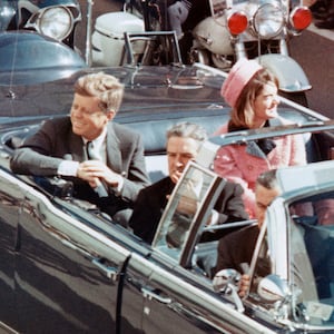 US President John F Kennedy, First Lady Jacqueline Kennedy, Texas Governor John Connally, and others smile at the crowds lining their motorcade route in Dallas, Texas, on November 22, 1963. Minutes later the President was assassinated as his car passed through Dealey Plaza.