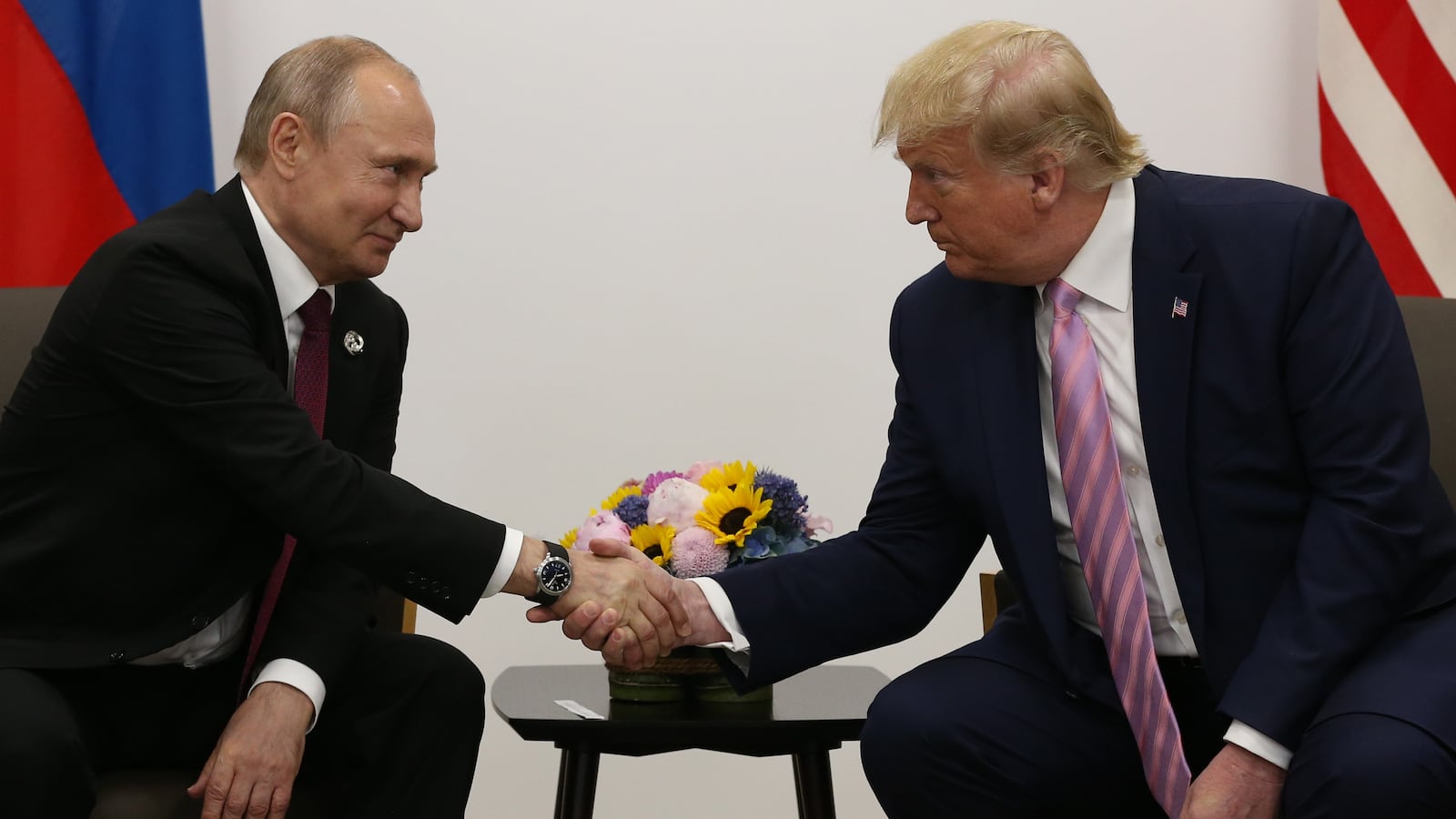 U.S. President Donald Trump (R) greets Russian President Vladimir Putin (L).