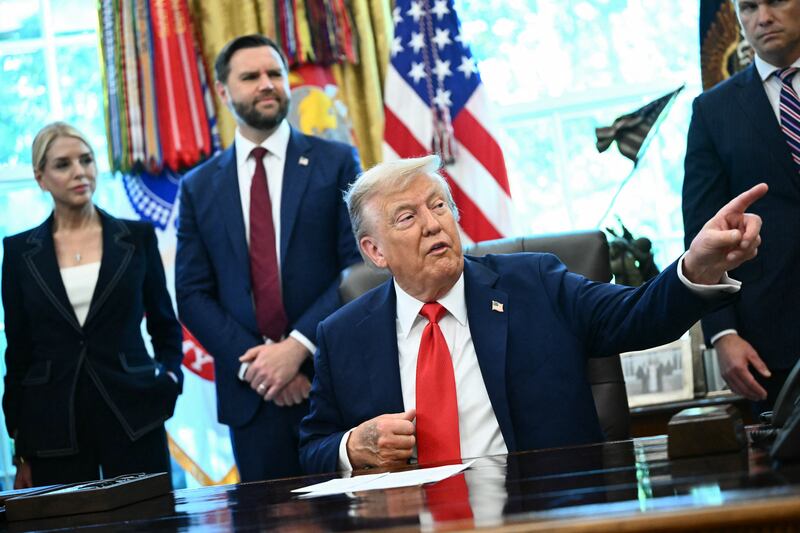 US President Donald Trump, alongside Attorney General Pam Bondi (L) and Vice President JD Vance (2L), speaks to the press before signing an executive order that aims to end cashless bail, in the Oval Office of the White House in Washington, DC on August 25, 2025.