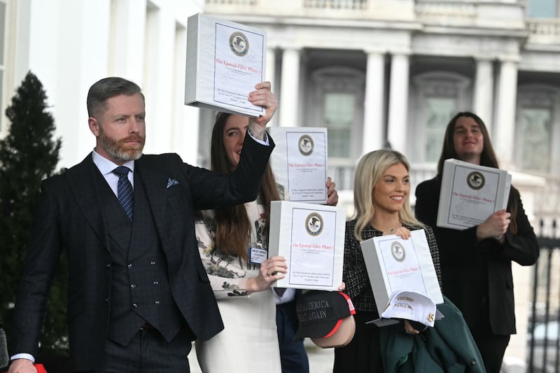 Political commentator Rogan O'Handley, aka DC Draino, TikToker Chaya Raichik, commentator Liz Wheeler and conservative activist Scott Presler carry binders bearing the seal of the US Justice Department reading "The Epstein Files: Phase 1" as they walk out of the West Wing of the White House in Washington, DC, on February 27, 2025.