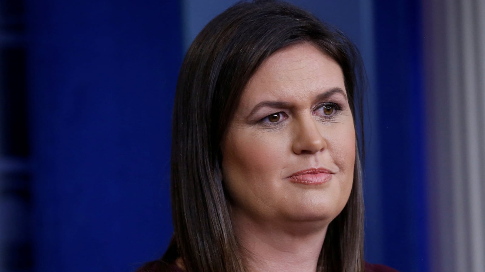Sarah Huckabee Sanders stands during a press conference