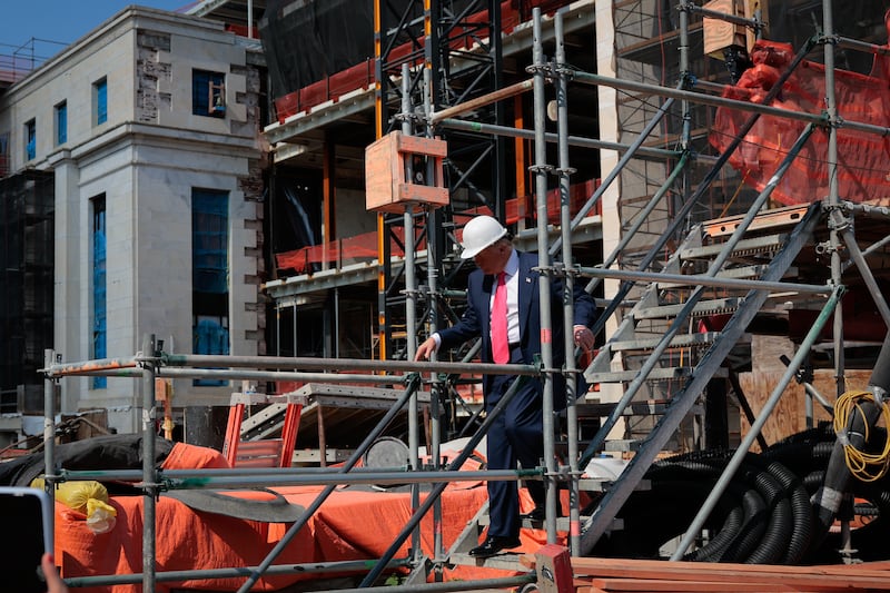 President Donald Trump climbs down a set of stairs as he tour the Federal Reserve’s $2.5 billion headquarters renovation project on July 24, 2025.