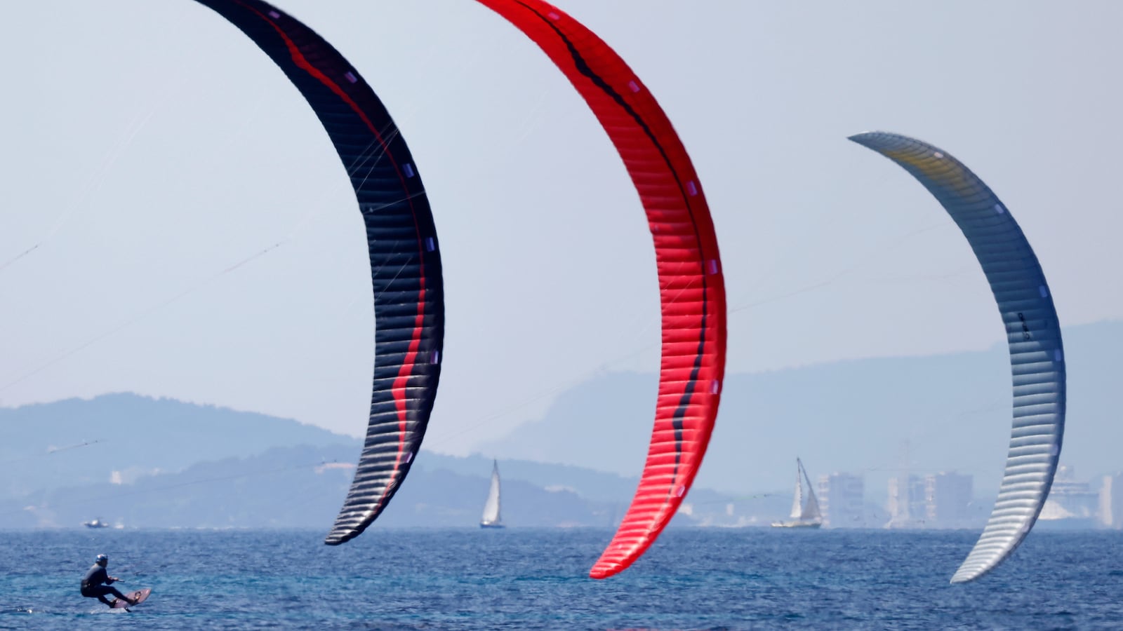 Three Kitefoilers race off the coast of France.