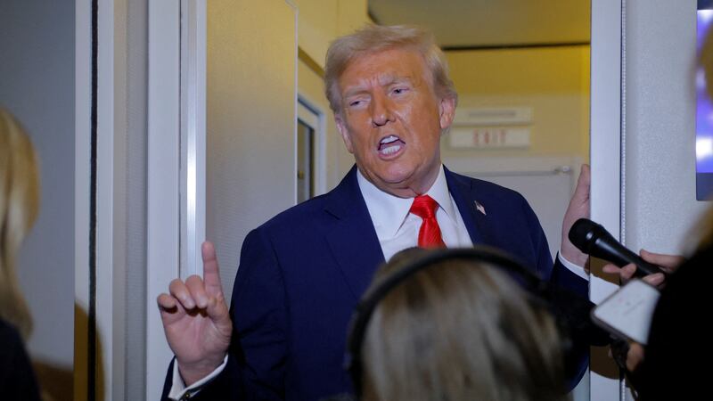 U.S. President Donald Trump answers a question from a reporter onboard Air Force One after attending the memorial service for slain conservative commentator Charlie Kirk, enroute to Joint Base Andrews, in Maryland, U.S. September 21, 2025. REUTERS/Brian Snyder