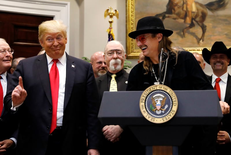 U.S. President Donald Trump speaks next to to Kid Rock