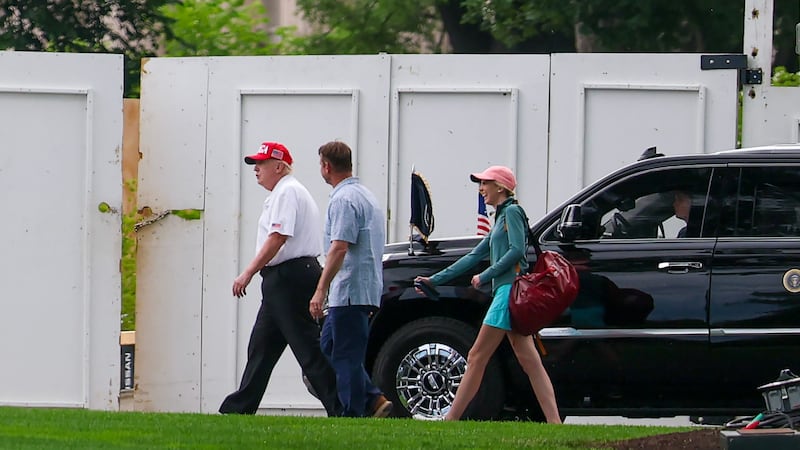 Donald Trump walks back to the White House with Executive Assistant to the President Natalie Harp