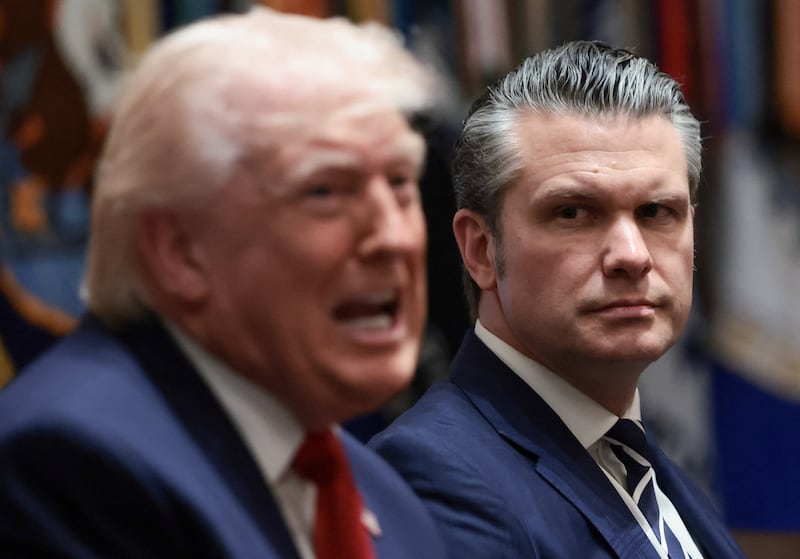U.S. President Donald Trump speaks next to Defense Secretary Pete Hegseth during a cabinet meeting at the White House in Washington, D.C., U.S., March 26, 2026