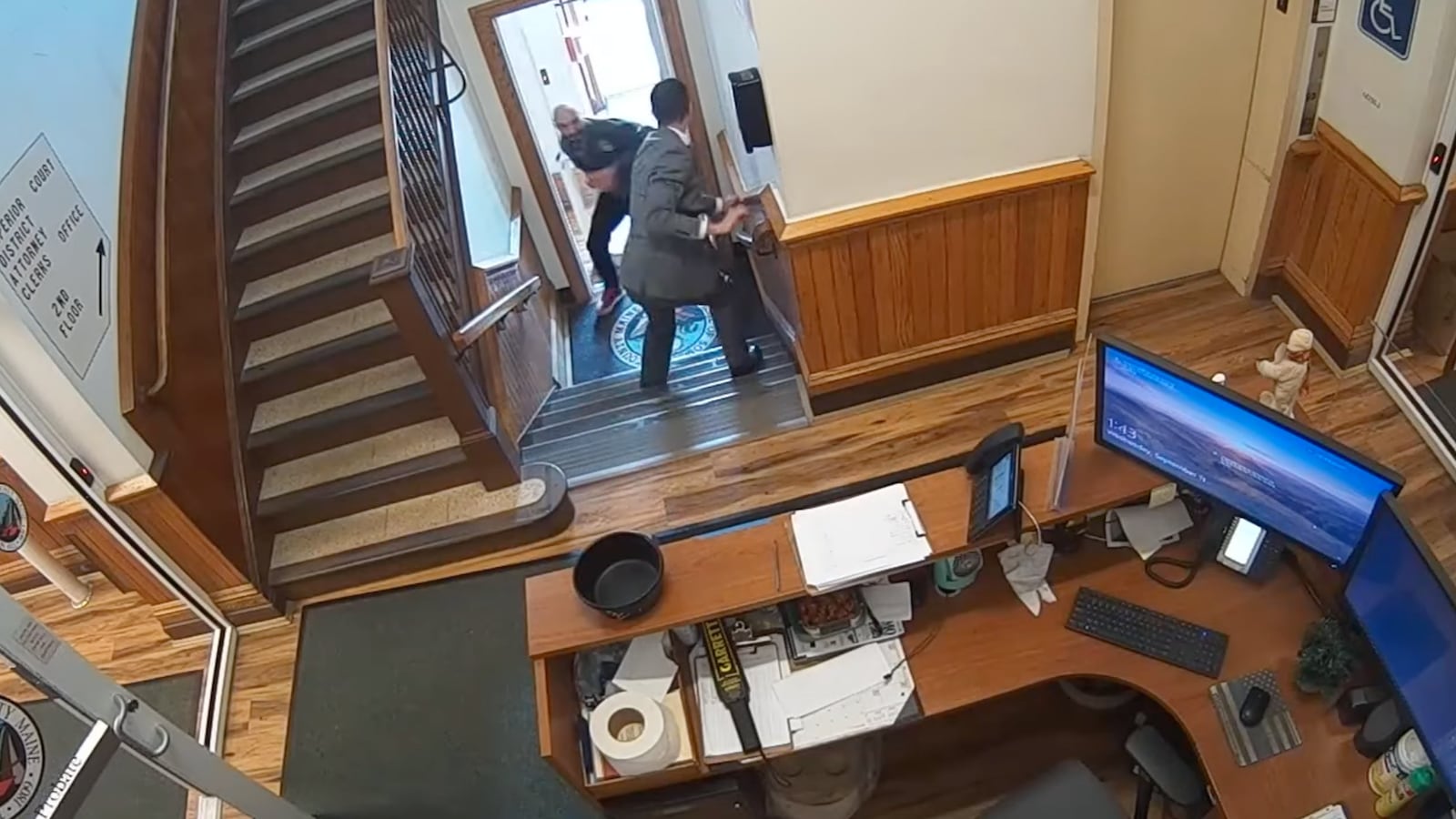 A video still shows a handcuffed Nicholas Carter facing a court official just before he turns and flees a courthouse in Skowhegan, Maine.