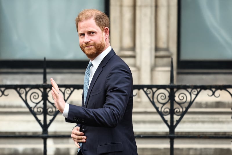 TOPSHOT - Britain's Prince Harry, Duke of Sussex waves as he leaves the High Court, in central London, on April 8, 2025 after an hearing about a decision of the British Government to downgrade his personal security during visits in Britain. Prince Harry's lawyer outlined in court threats made against him, as King Charles's youngest son appealed on April 8, 2025 against an "unjustified" decision to restrict his police protection in the UK. Harry, who has been angered by the government's decision, watched proceedings unfold from inside London's Royal Courts of Justice during a rare visit to London. (Photo by HENRY NICHOLLS / AFP) (Photo by HENRY NICHOLLS/AFP via Getty Images)